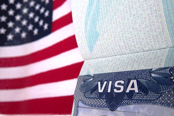 A U.S. visa beside an American flag