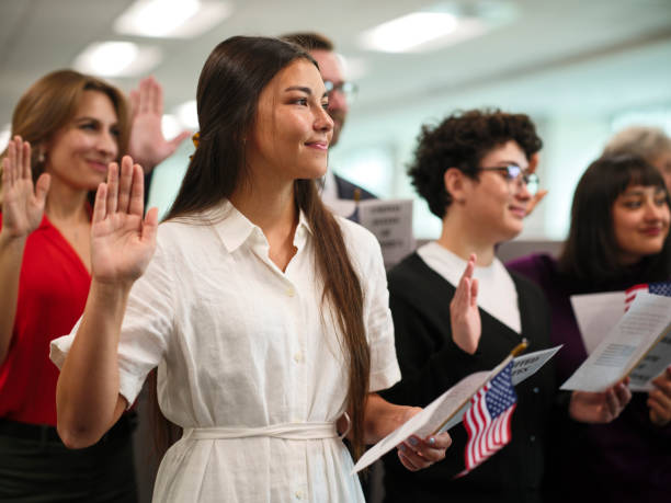 New citizens raising their right hands at a naturalization ceremony