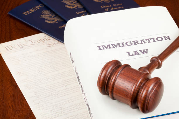 A gavel and an immigration law book with U.S. passports