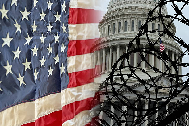 The U.S. Capitol behind a fence with an American flag