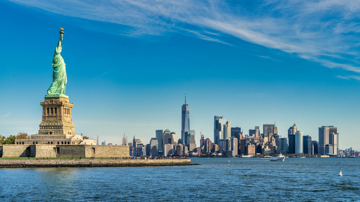 Statue of Liberty with the Lower Manhattan skyline across the harbor